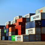 Colorful stacked shipping containers at a port exemplify global logistics.